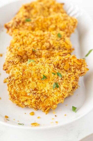 close up of potato chip chicken on a white platter