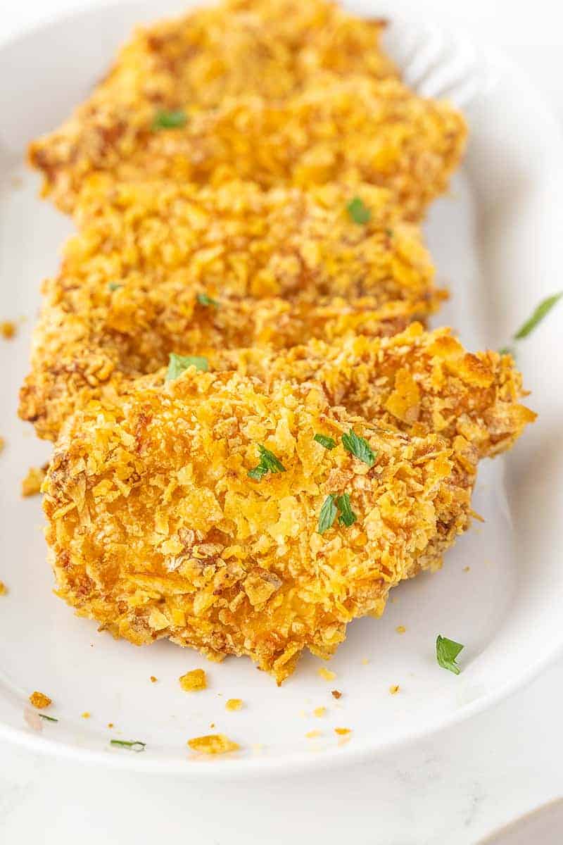 close up of potato chip chicken on a white platter