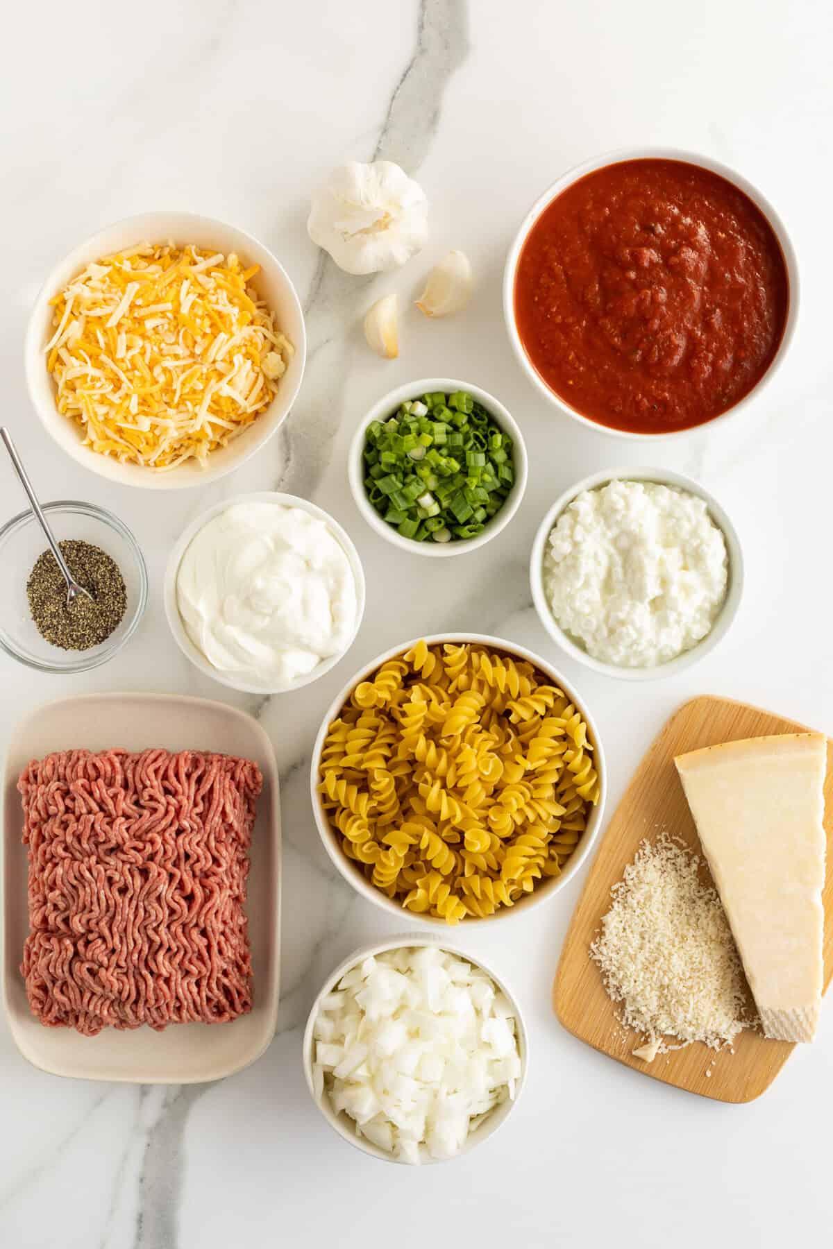 sour cream noodle bake ingredients in white bowls of varying sizes