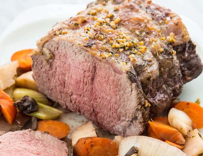 Sliced Slow Cooker Red Wine Striploin Roast Beef Served with Vegetables and Gravy