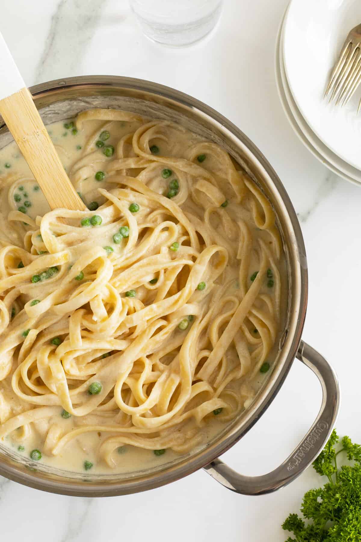 5 ingredient cream cheese Alfredo sauce in a pot with a wooden spoon