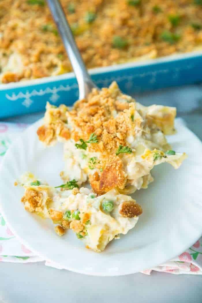 Chicken and Egg Noodle Casserole with Ritz Topping being spooned onto a white plate