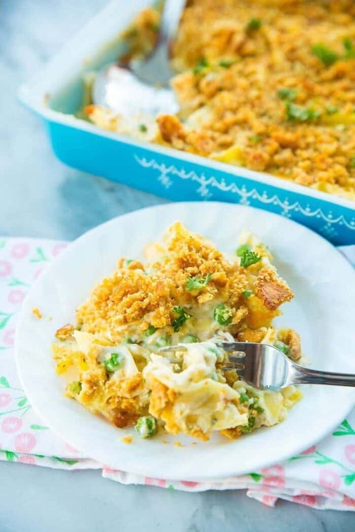 Chicken and Egg Noodle Casserole with Ritz Topping on a white plate and a fork in it