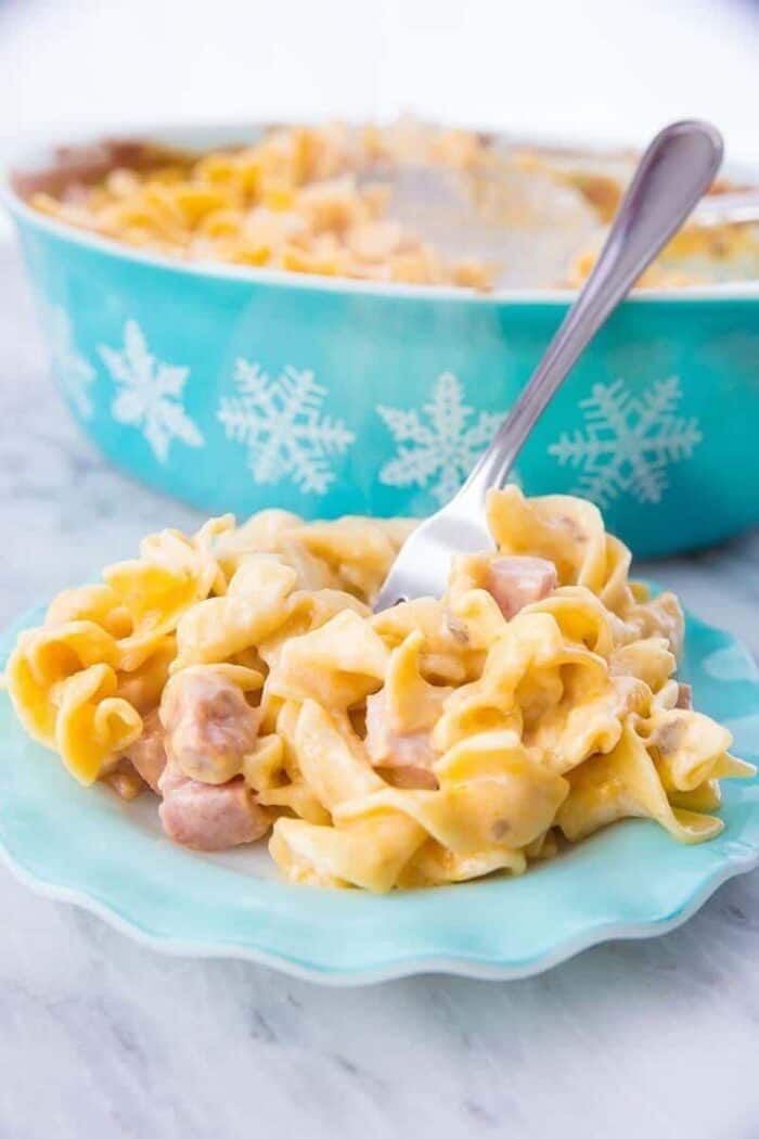  Creamy ham & noodle casserole on a vintage Hazel Atlas ruffled turquoise plate with a fork