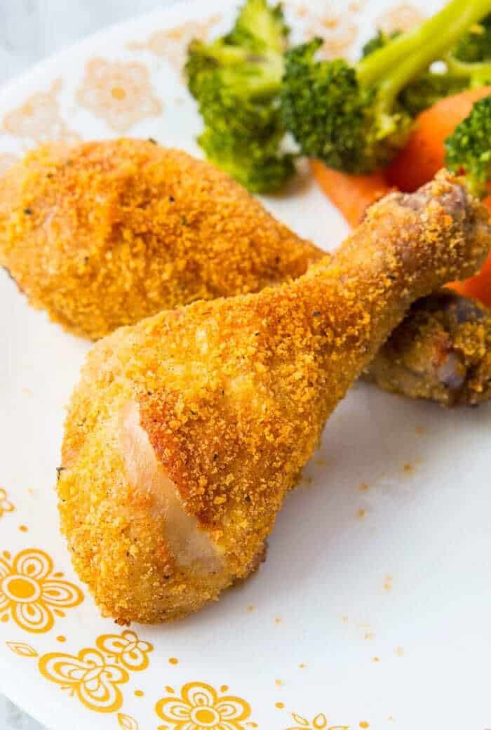 Crispy Oven Baked Chicken Legs on a vintage Corelle Butterfly Gold Plate