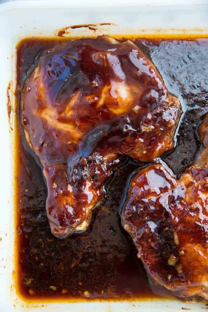 pork chops in the bottom of baking pan together with the sauce