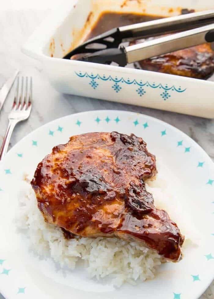 Saucy Brown Sugar Baked Pork Chops with Pyrex Snowflake Garland pan in the background