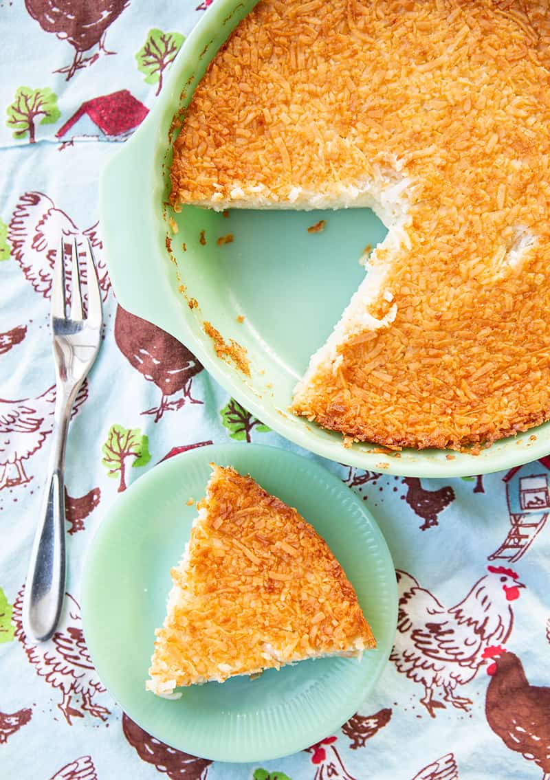 Retro Coconut Impossible Pie in a mint green pie plate and a slice in a mint green dessert plate