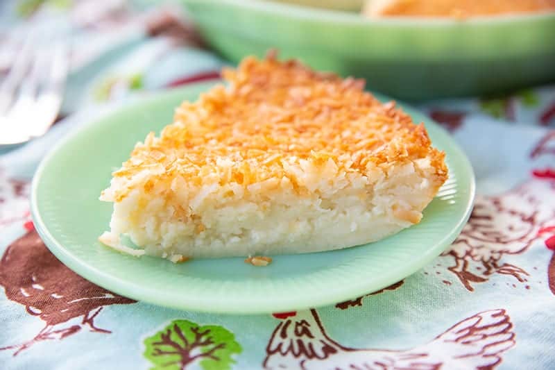 slice of Retro Coconut Impossible Pie in a mint green dessert plate