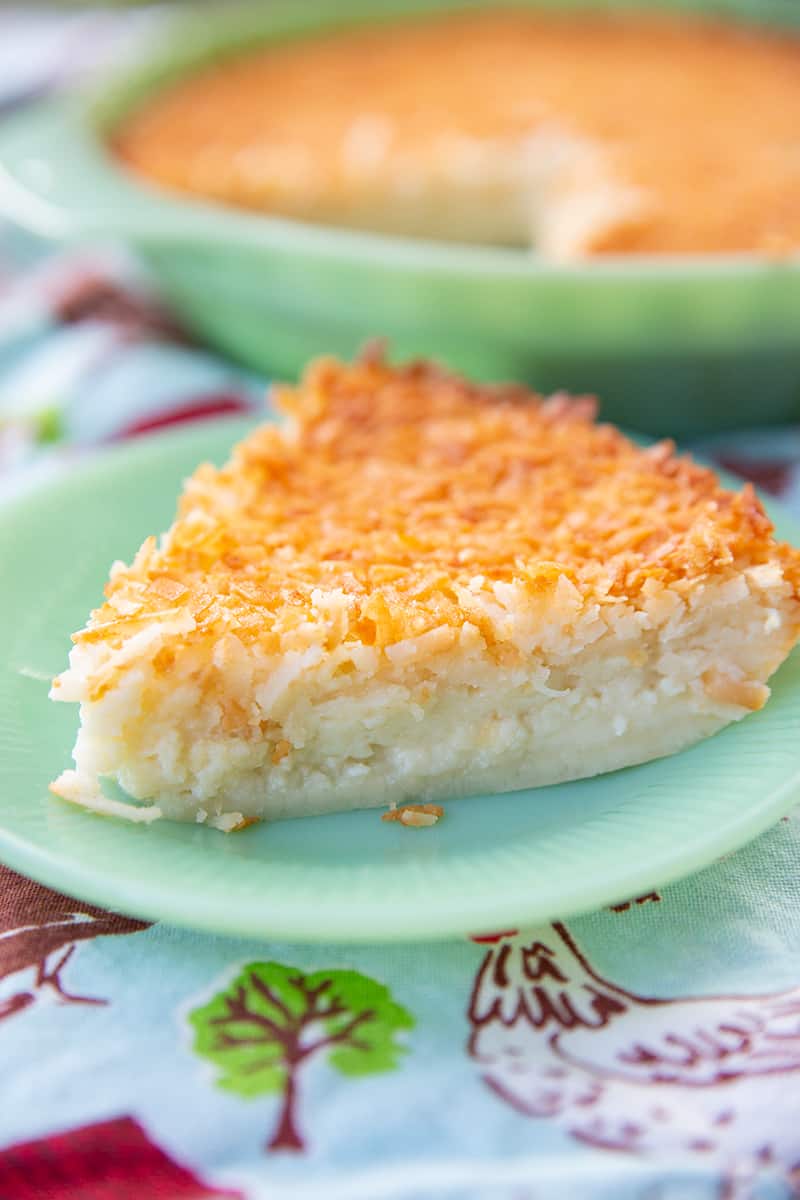 close up slice of Retro Coconut Impossible Pie in a mint green dessert plate