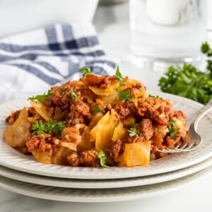 lazy cabbage casserole on a stack of white plates