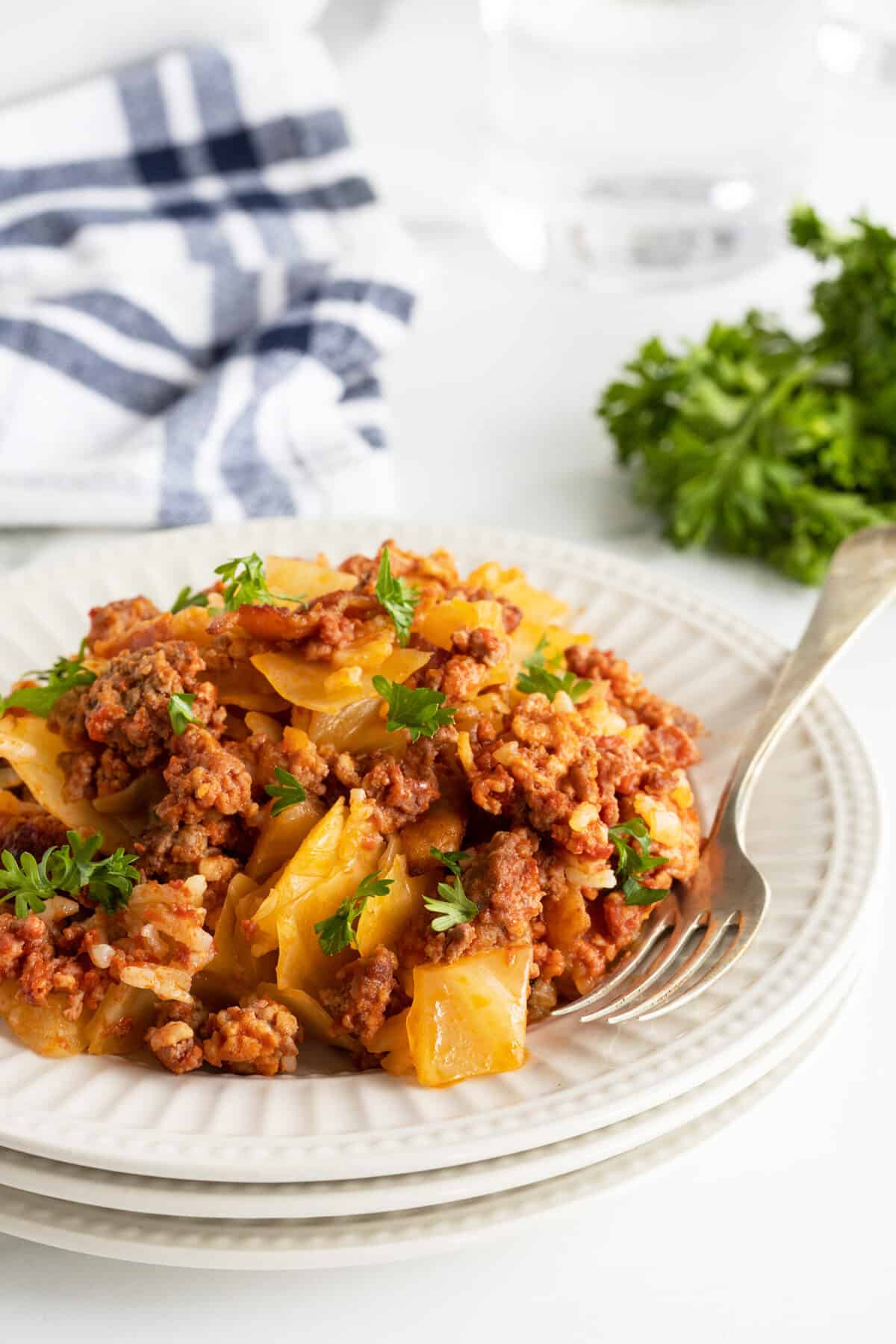 lazy cabbage casserole on a white plate with a fork