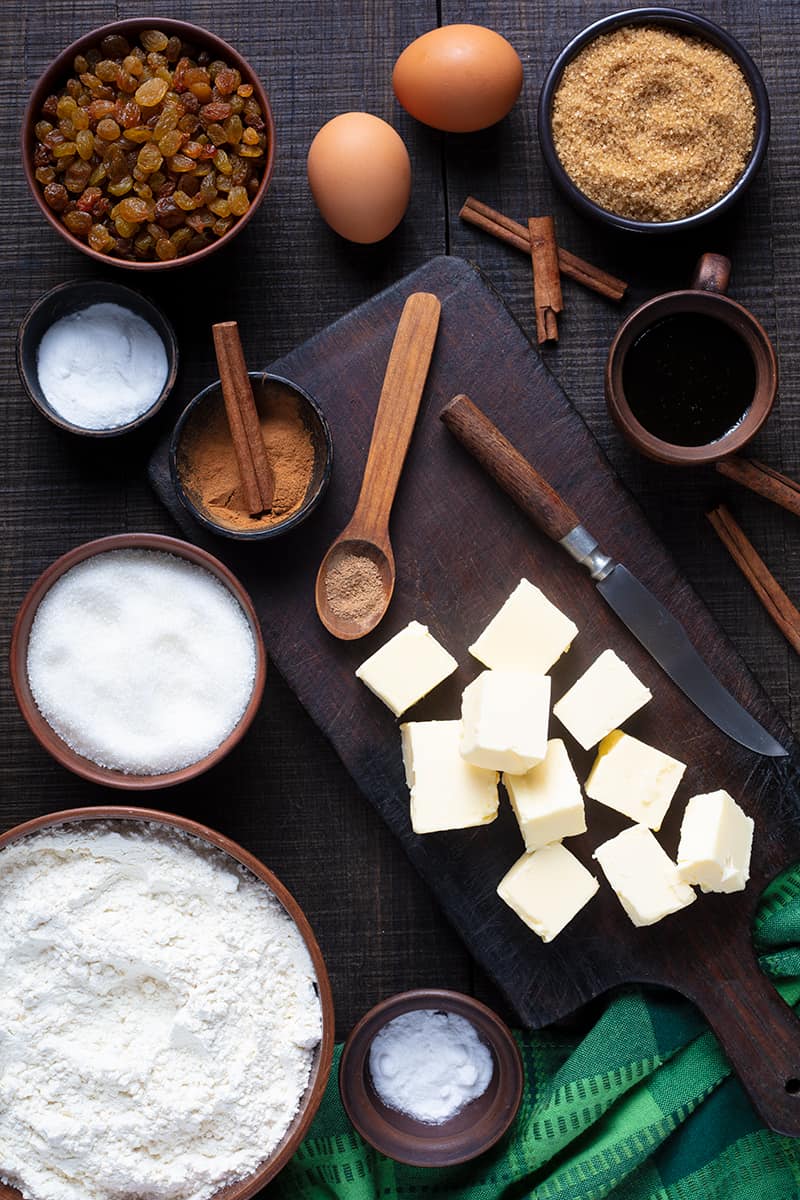 Molasses Bars (Hermit Bars) ingredients in a chopping board on a dark wood background