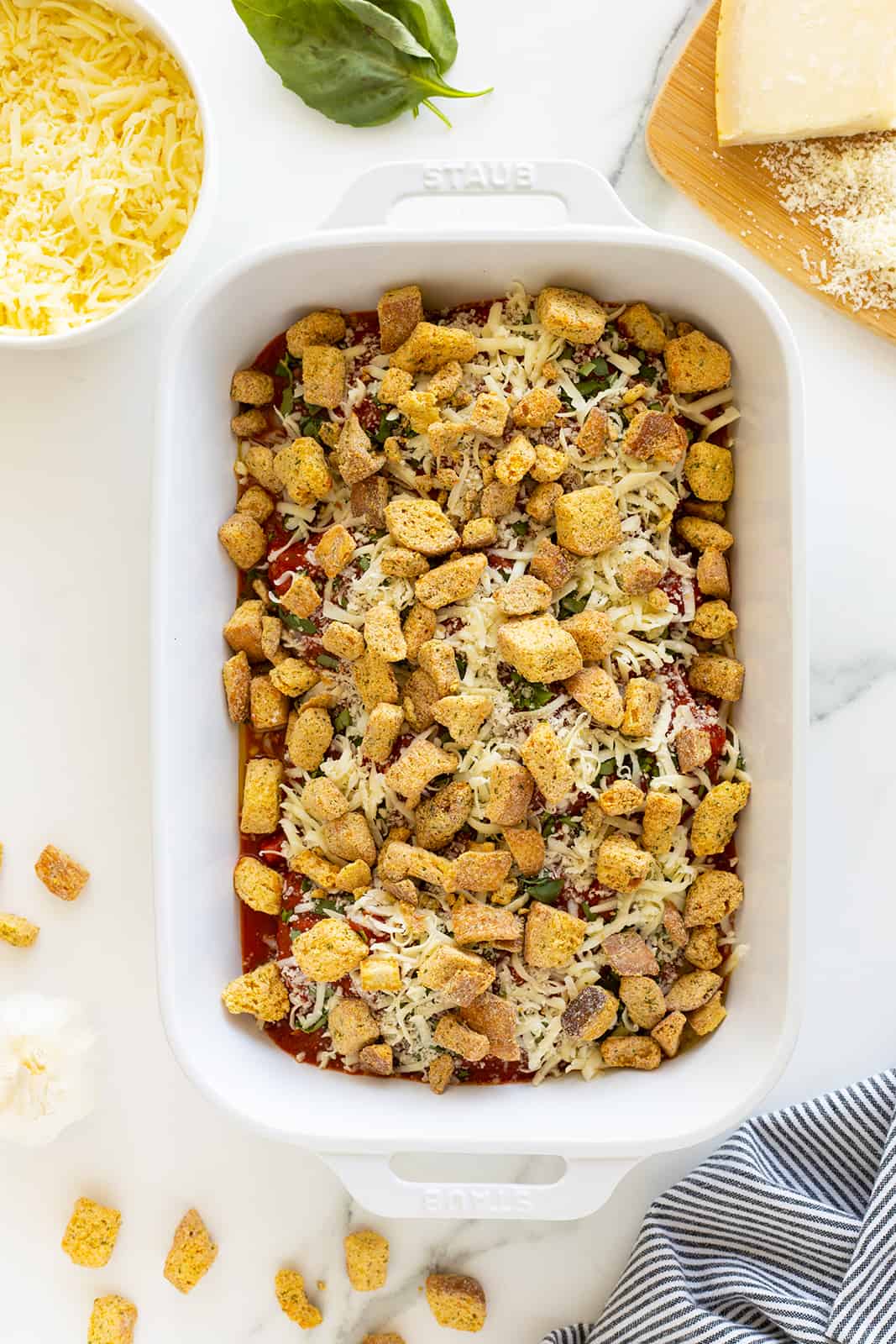 Chicken Parmesan Casserole in the pan with croutons on top unbaked