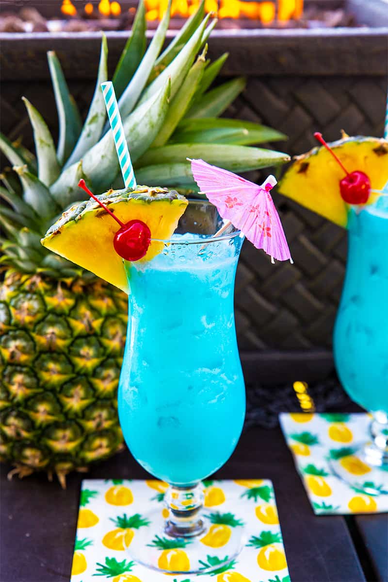 Blue Hawaiian Cocktail in a Hurricane Glass with a slice of pineapple