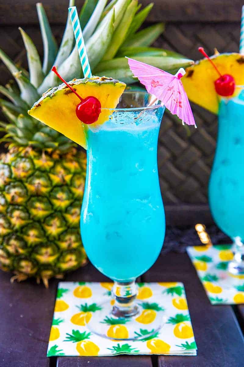 Blue Hawaiian Cocktail in a Hurricane Glass with a slice of pineapple