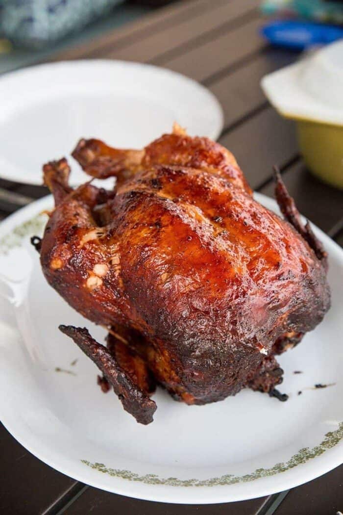 barbecue rotisserie chicken on a white platter