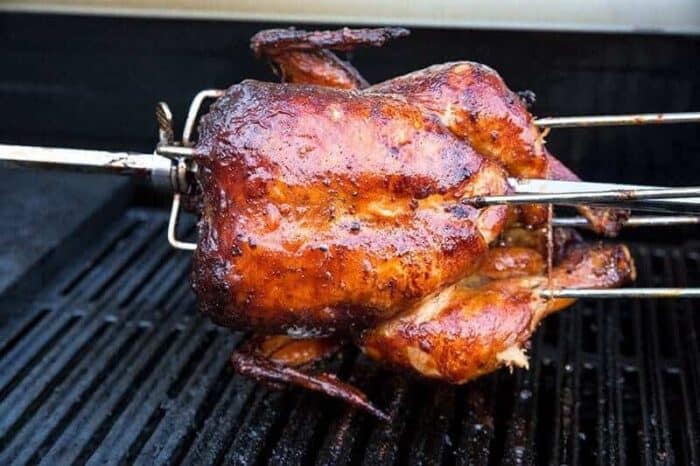 BBQ Five-Spice Rotisserie Chicken in spit rod