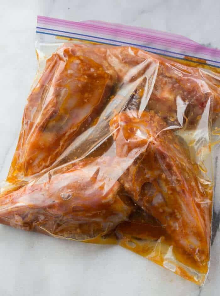 Sealing bag with chicken and marinade inside