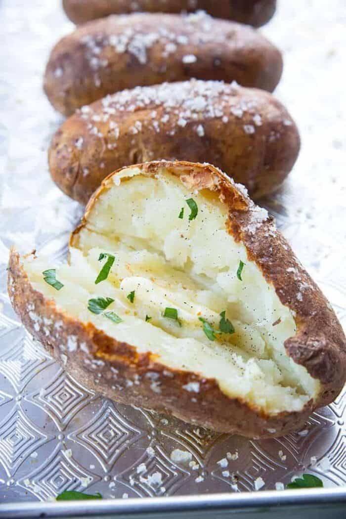 Baked Potatoes with butter and green parsley