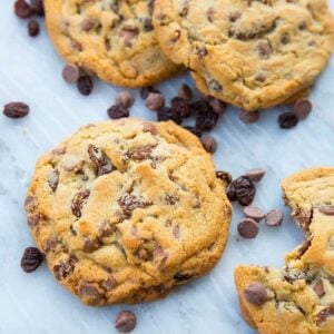 Close up of Milk Chocolate Chip Cookies with Raisins on white marble slab