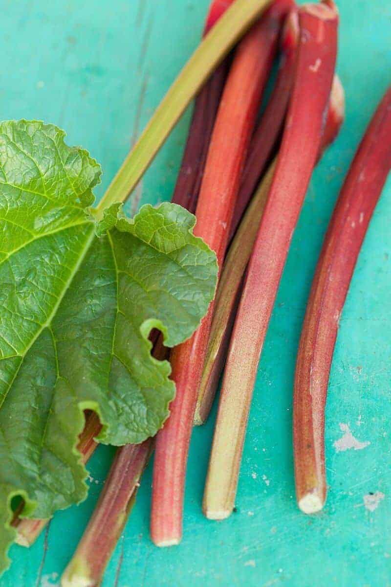 Rhubarb stalks on a turquoise wood board