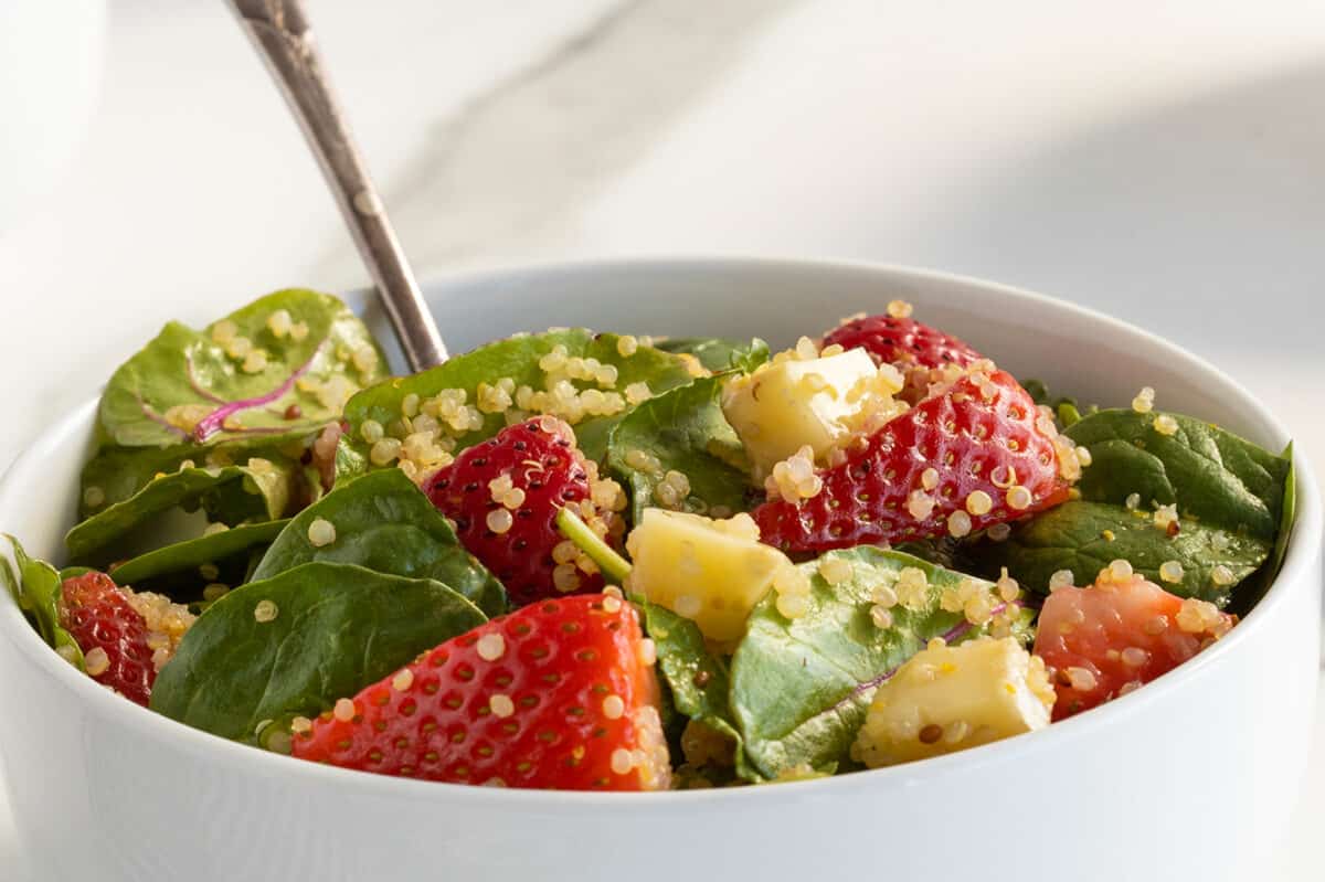 strawberry quinoa salad closeup in a white bowl