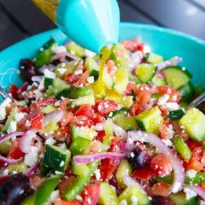 Homemade Greek Salad Dressing Drizzled on Greek Salad