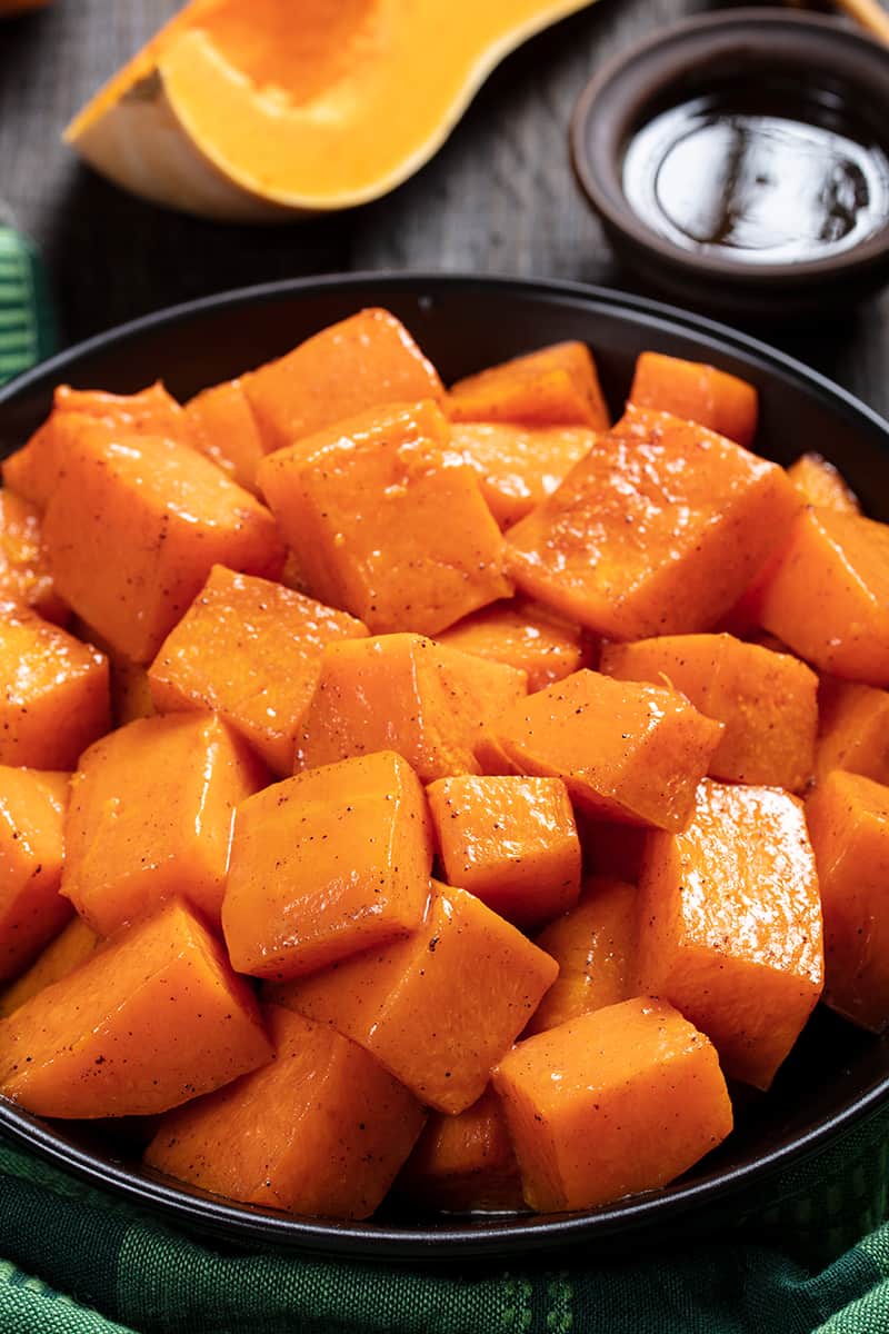 close up black serving plate with Honey & Cinnamon Roasted Butternut Squash