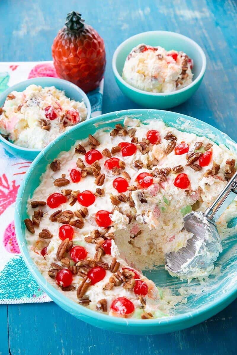 scooping Hawaiian Cheesecake from a large jade blue serving bowl