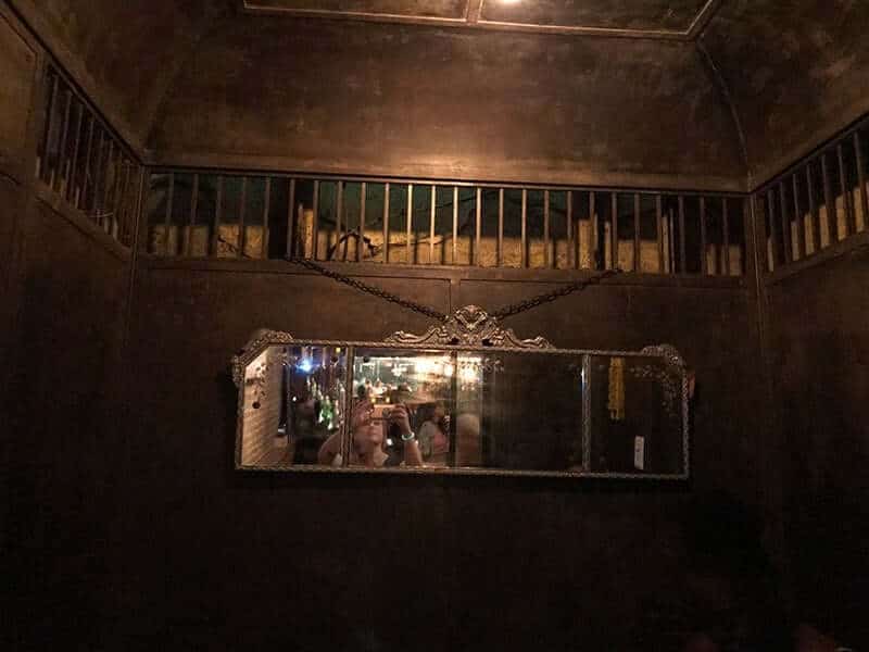 lady facing the mirror at haunted elevator at Dean's taking photo