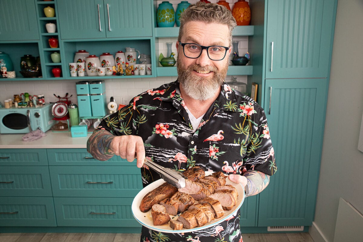 Mike Johnston holding a platter of his grilled honey garlic pork tenderloin