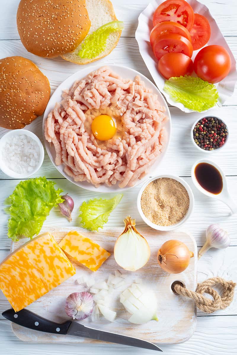 top down shot of all the ingredients needed in making Turkey Burgers in a white background