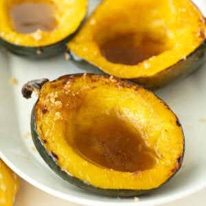 baked cuts of Acorn Squash in a white plate