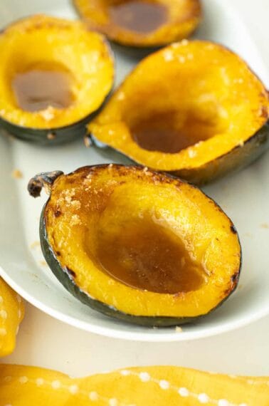 baked cuts of Acorn Squash in a white plate