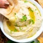 dipping an oven baked pita chip into Baba Ganoush