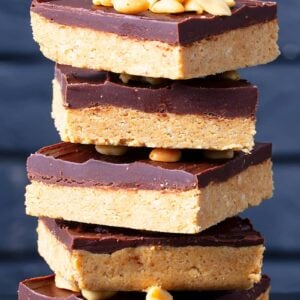 stack of Peanut Butter Bars top with roasted peanuts
