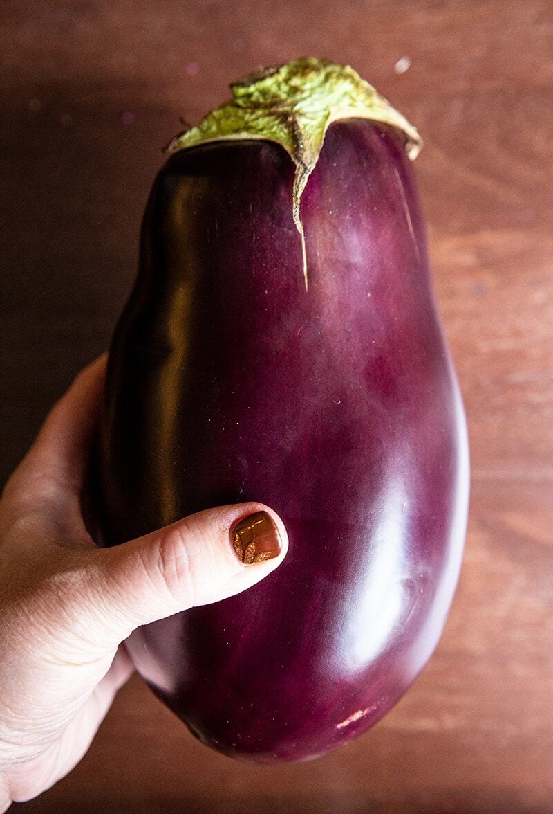 close up of a large, round and fat whole globe eggplant