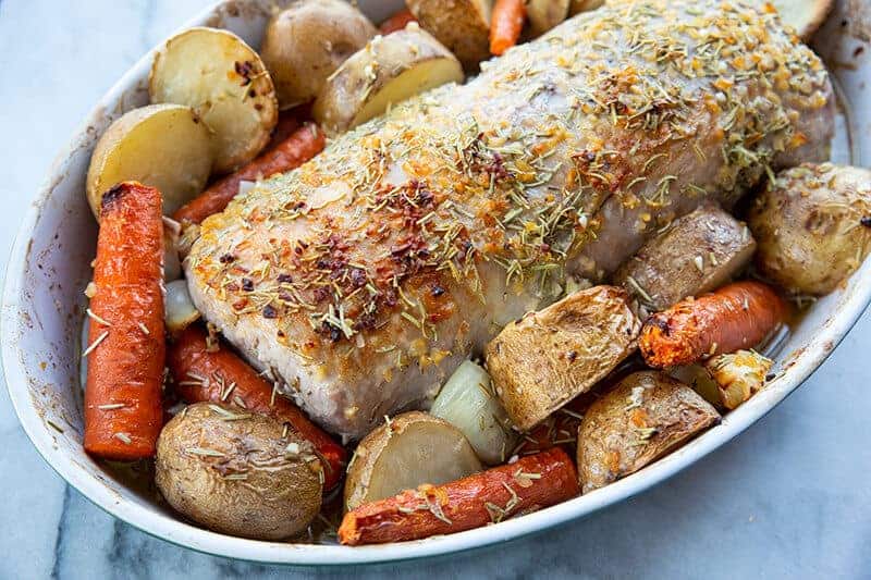 seasoned boneless Pork Loin Roast in a pan with potatoes and carrots