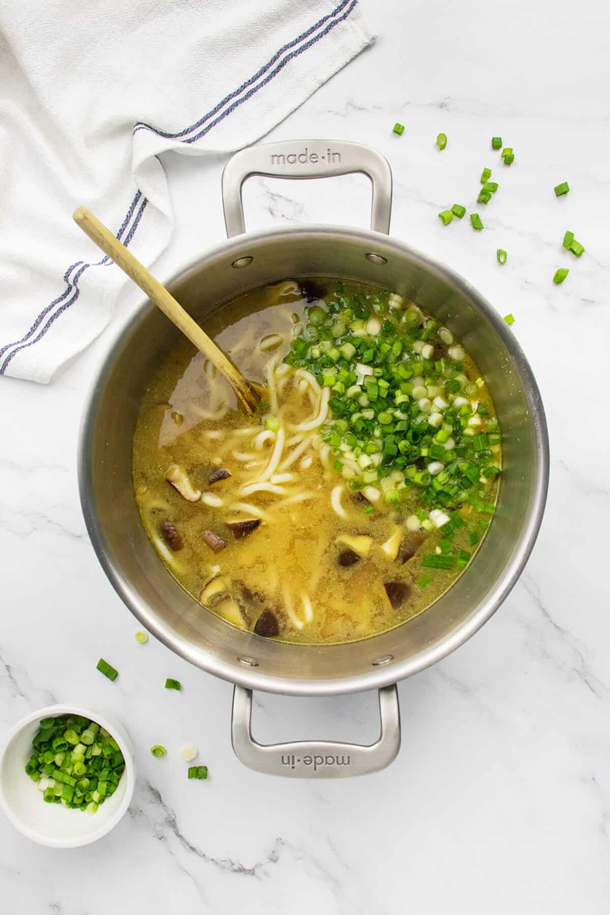 Chicken Mushroom Udon Noodle Soup in a pot with green onions