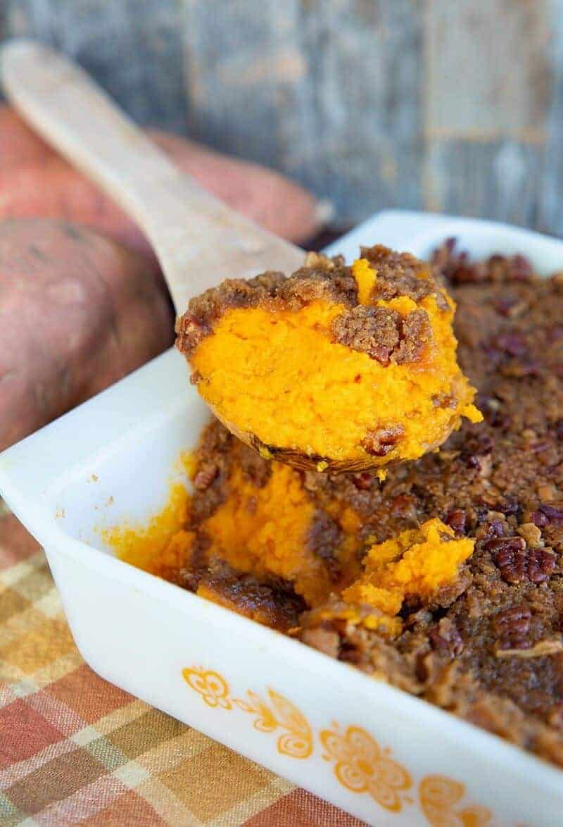 Sweet Potato Casserole in a Vintage Pyrex Butterfly Gold Casserole with a wooden sppon