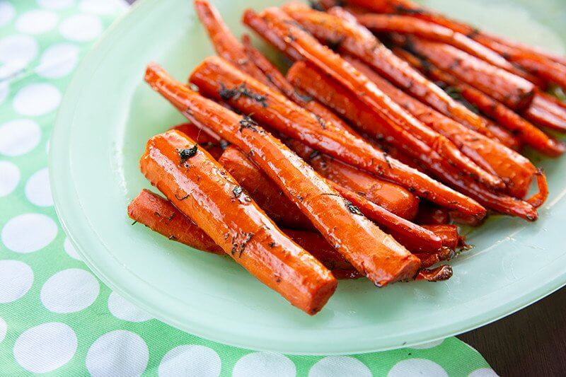 Dill & Brown Sugar Roasted Carrots in a mint green plate