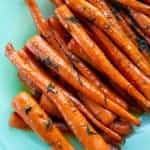 roast sliced carrots with dill in a serving tray