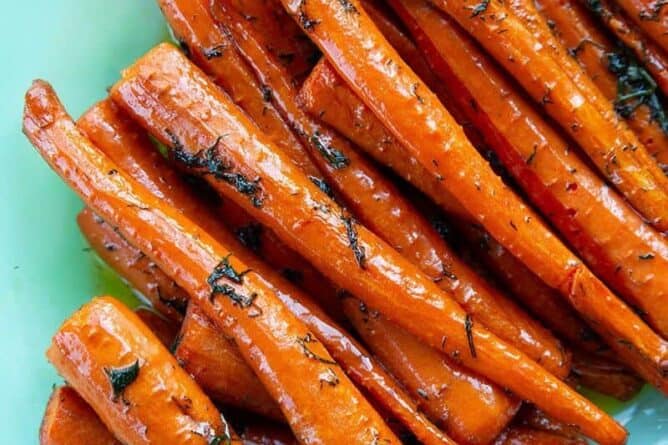roast sliced carrots with dill in a serving tray