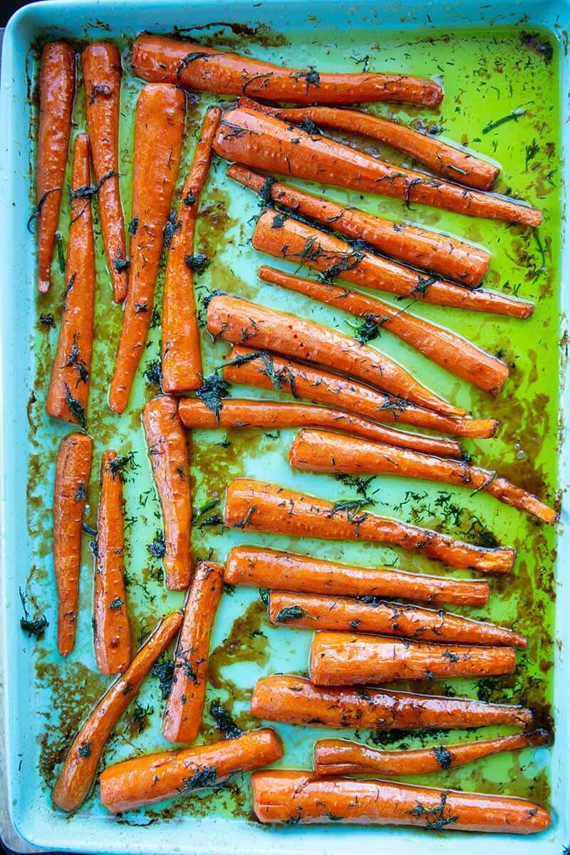 roast sliced carrots with dill in a baking pan