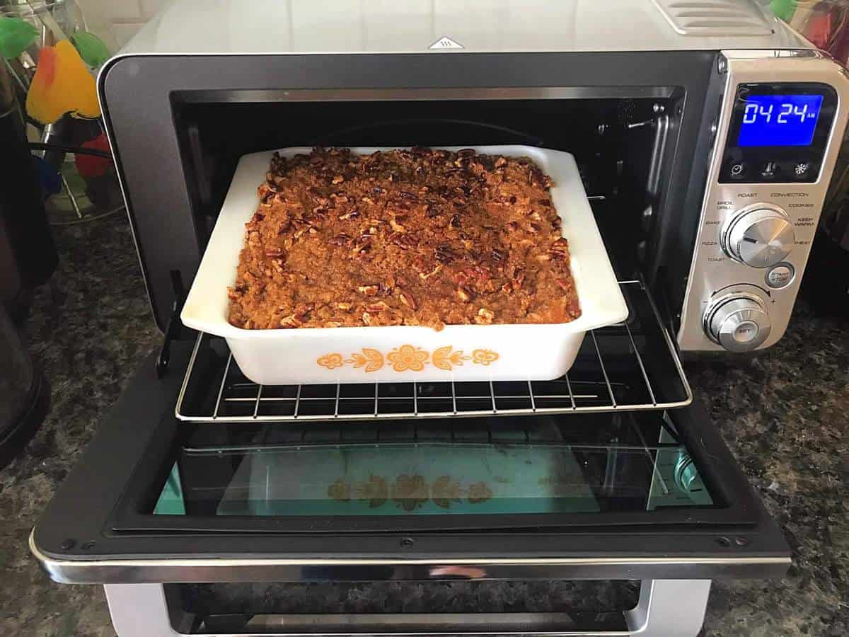 smooth and silky sweet potato casserole with crunchy and sweet pecan toppings