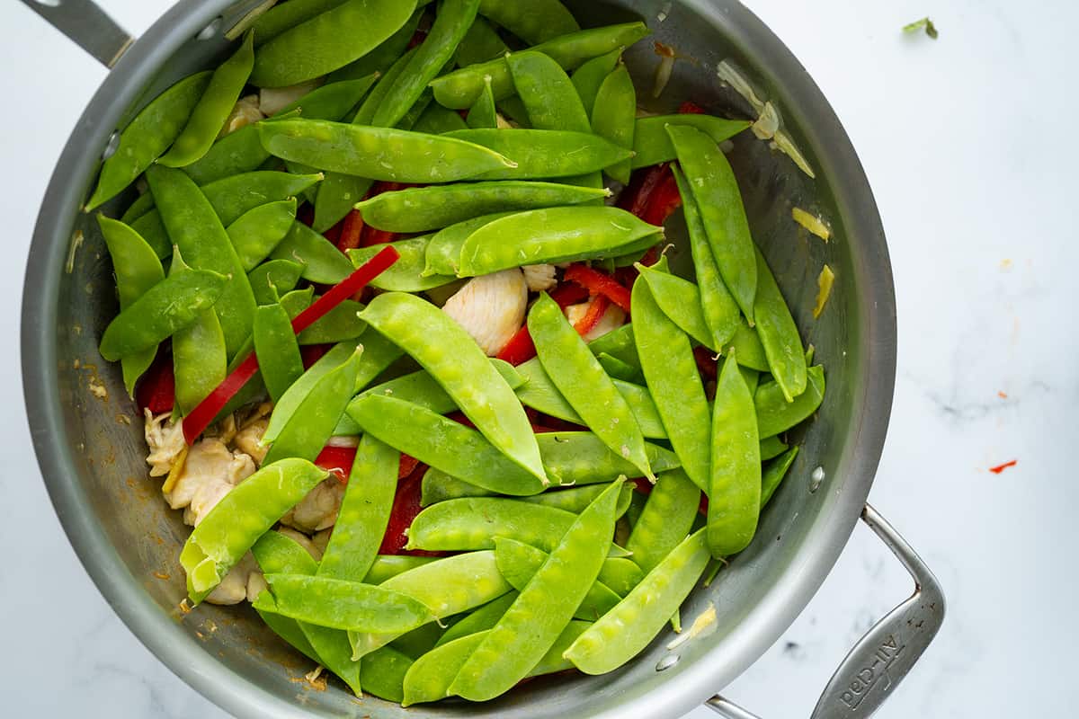 fried chicken and vegetables in a large pan