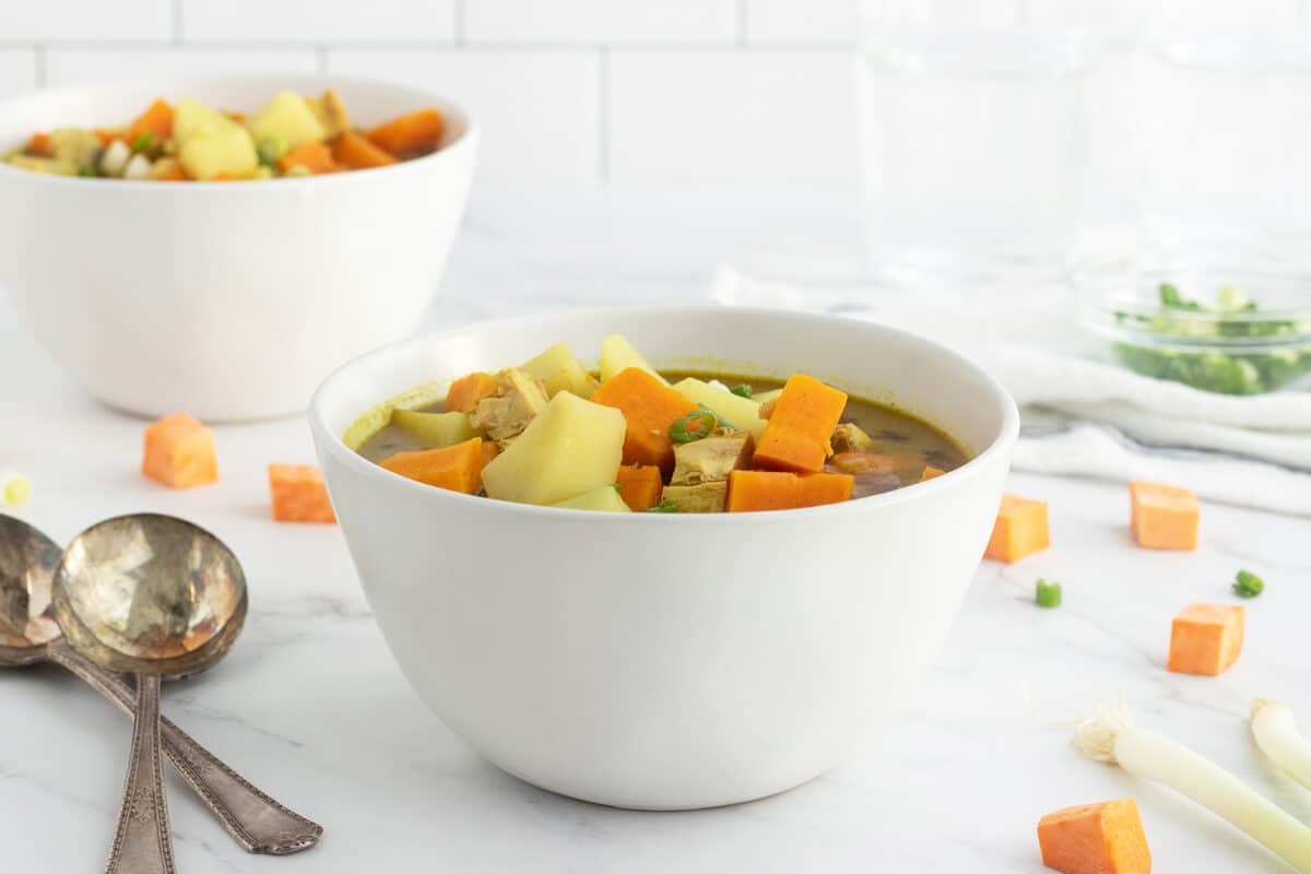 curried sweet potato and chicken soup in a white bowl