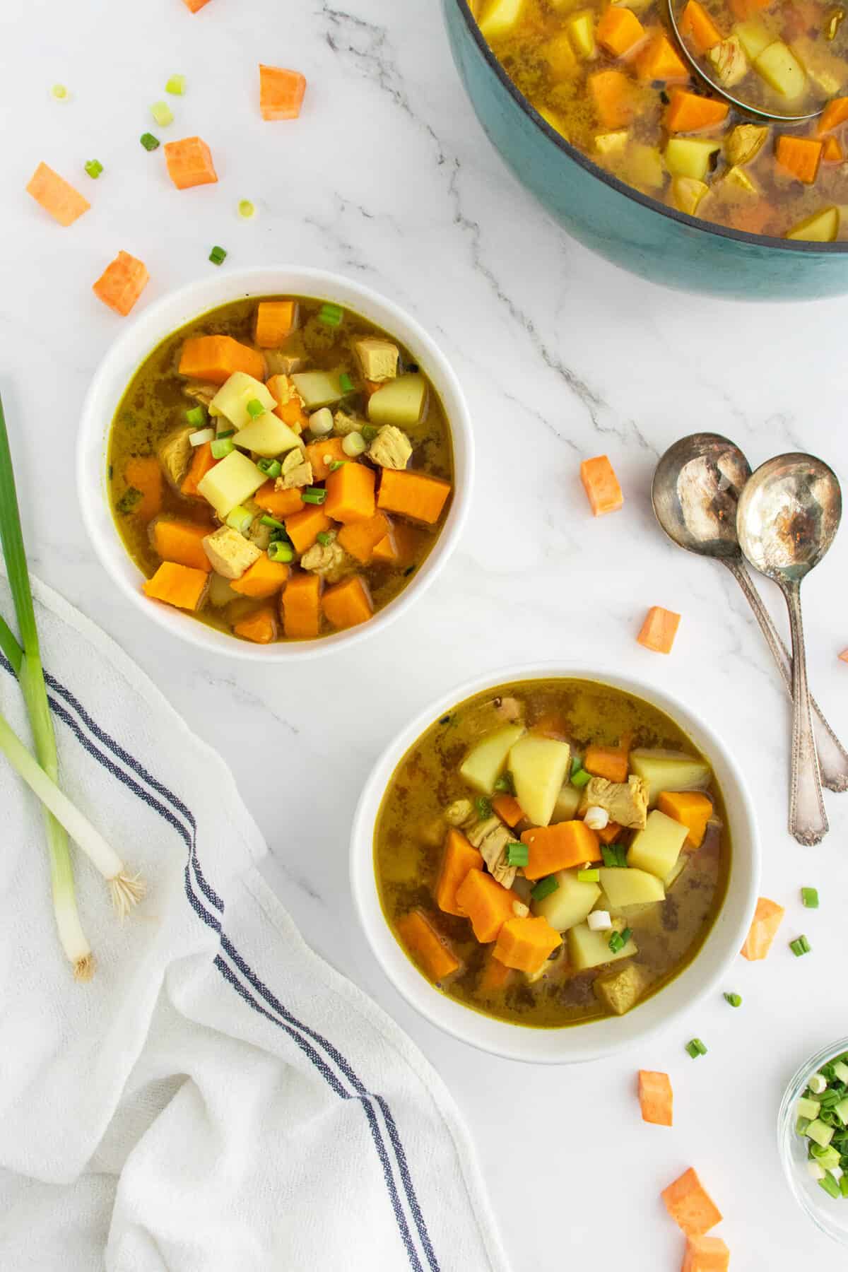 curried sweet potato and chicken soup in two bowls