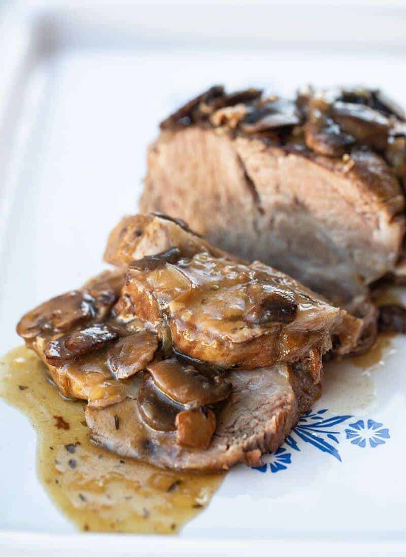 sliced Boston Butt Roast with Mushroom Gravy in a white plate